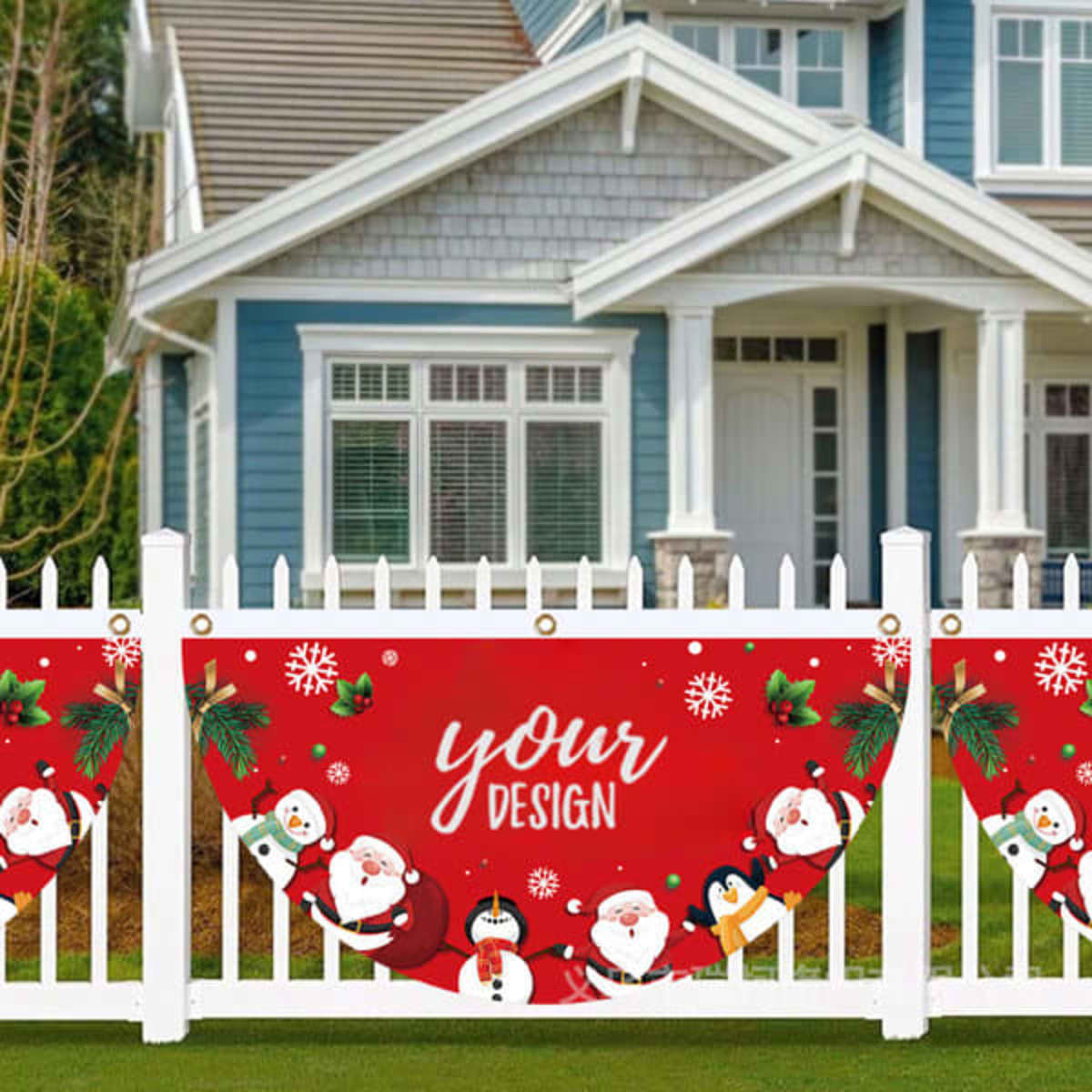 A red outdoor hanging fan flag featuring festive characters and designs, displayed on a white picket fence.