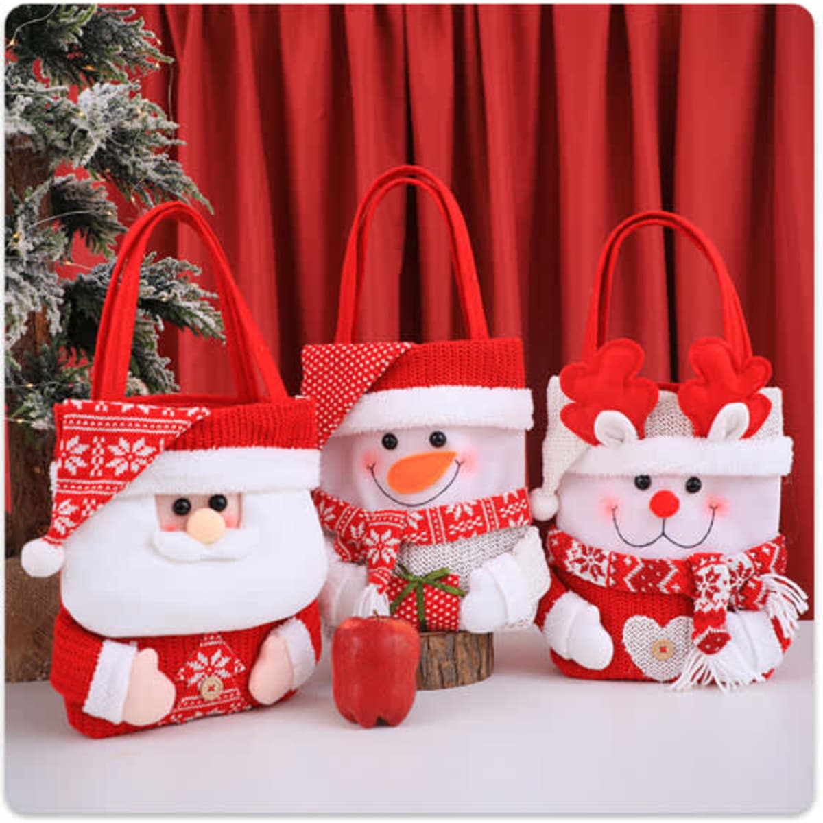 Three custom knitted Christmas gift bags featuring Santa, a snowman, and a reindeer, predominantly in red with festive details.