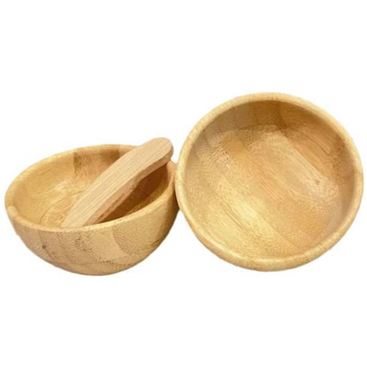 Two bamboo mixing bowls in natural colour, one with a wooden spatula resting inside. Contains a logo.