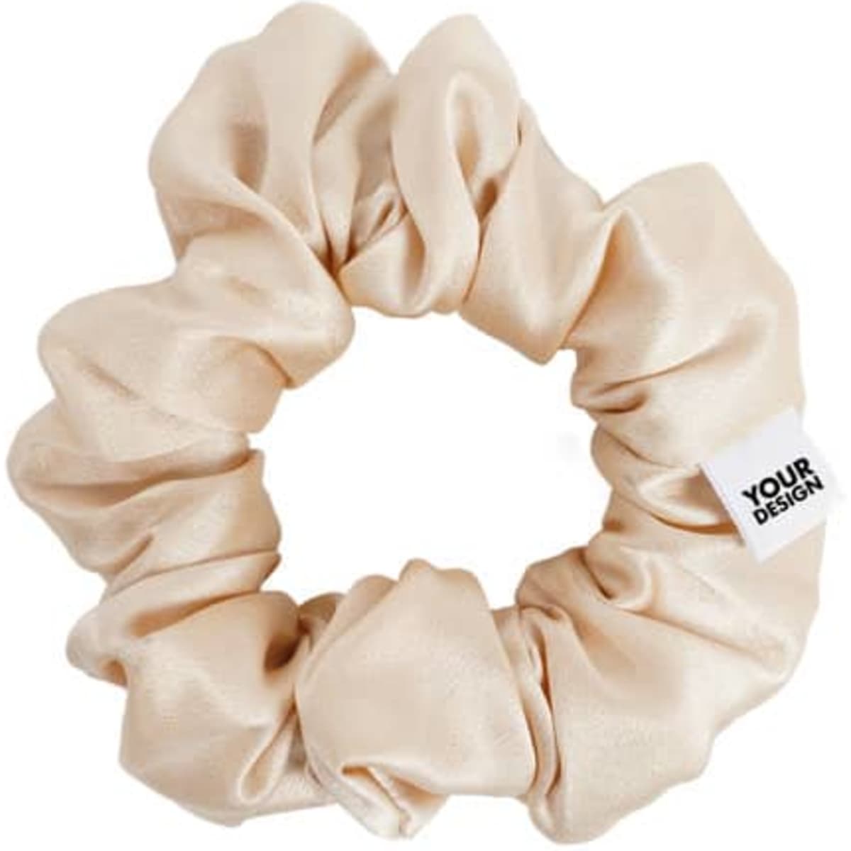 A beige satin scrunchie featuring a small tag with branding. Soft and luxurious texture showcased in a round shape.