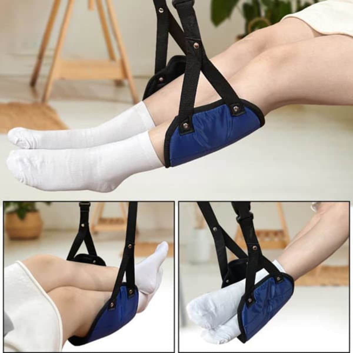 A portable footrest in navy blue with adjustable straps, designed for use during travel, featuring padded support.