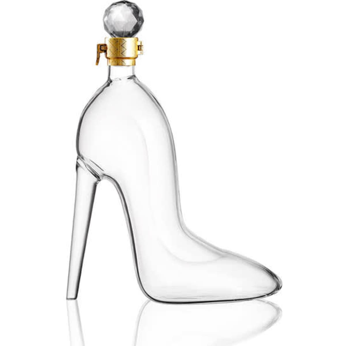 A drink bottle in the shape of a high-heeled shoe, made from clear glass with a gold and crystal stopper.