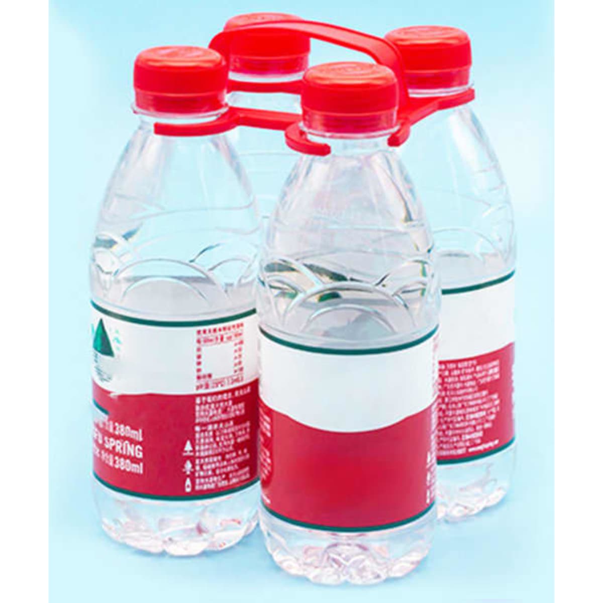Four plastic water bottles held together with a red holder against a light blue background.
