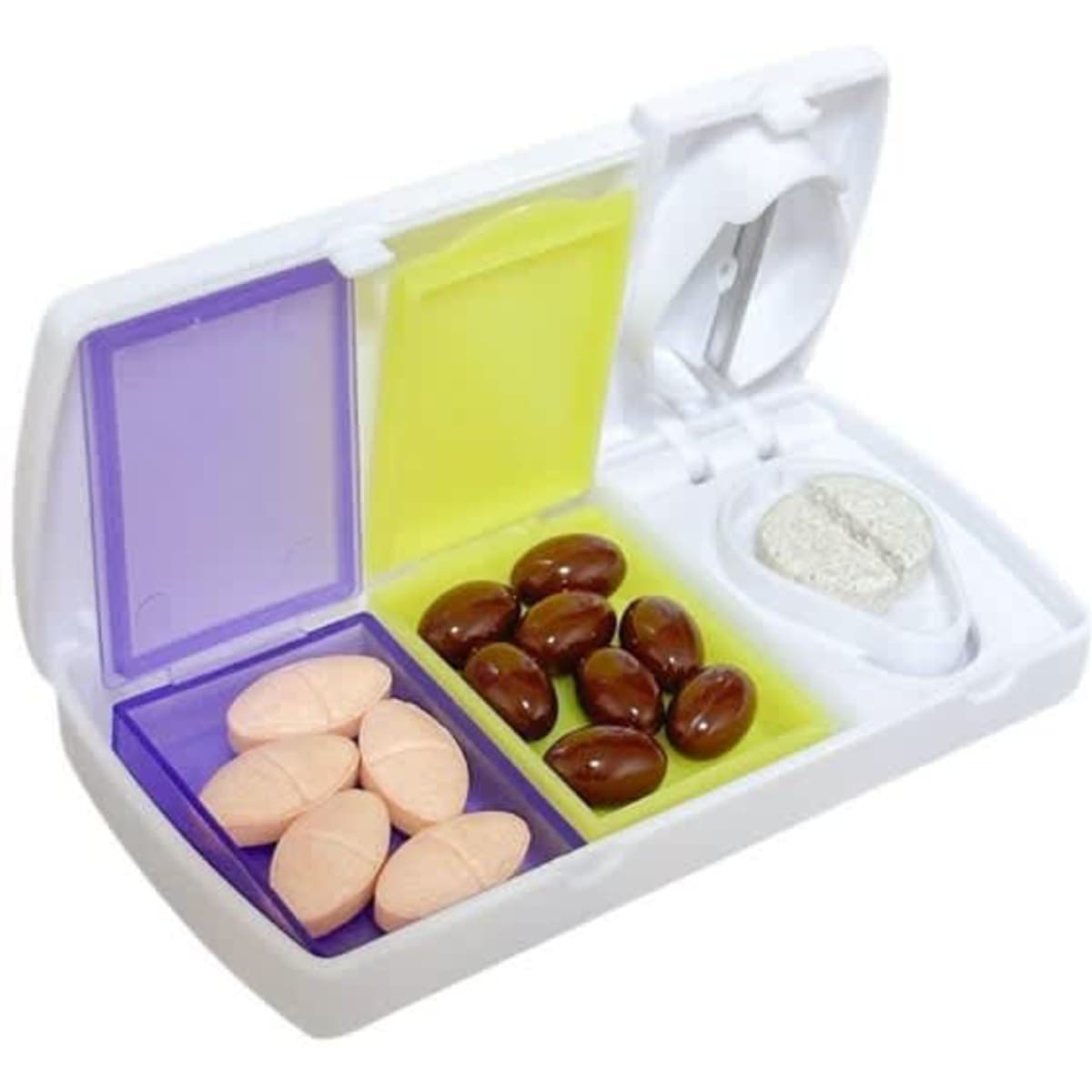 A white travel pill organizer with purple and yellow compartments, containing various shaped tablets and a pill cutter.