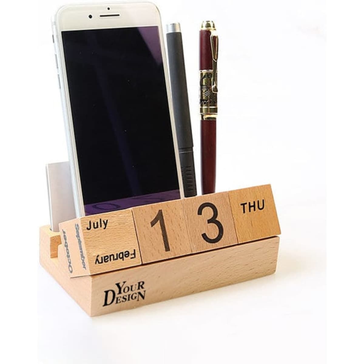 A wooden perpetual calendar featuring a pen holder and space for a smartphone, with a natural finish.