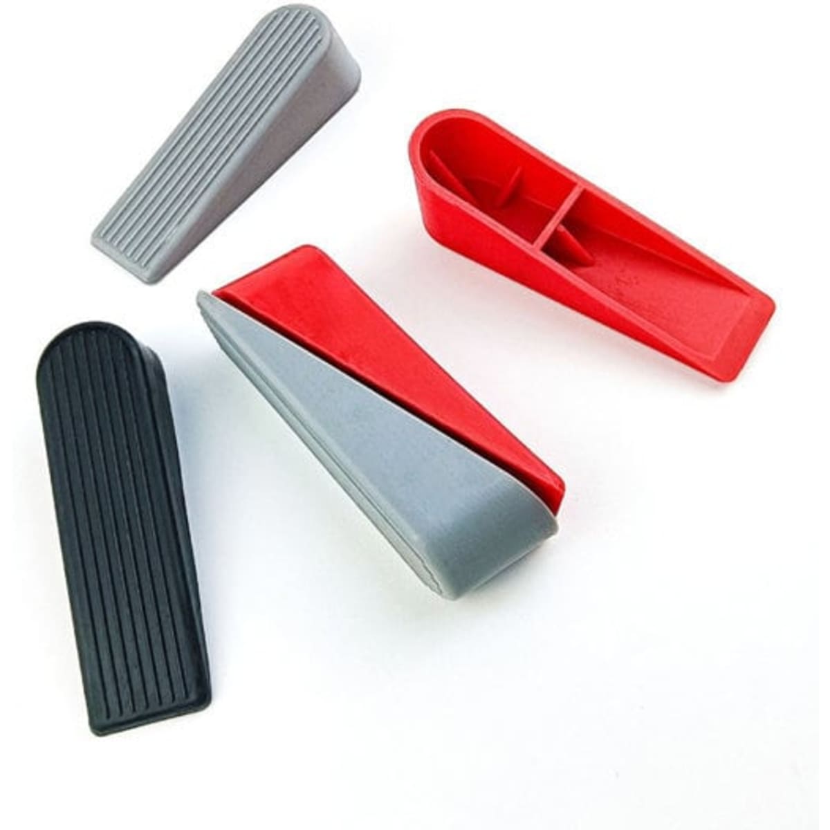 A set of four silicone door stops in red, grey, and black, featuring different designs and grooves.