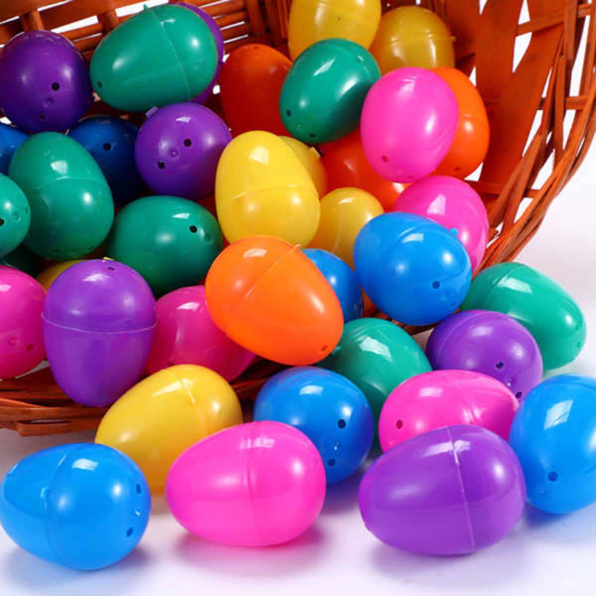 A basket filled with colourful plastic Easter eggs in shades of green, purple, pink, orange, and yellow.