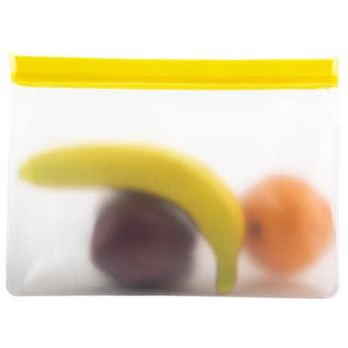 A clear PEVA food storage bag containing a banana, an orange, and a purple fruit, with a yellow zipper closure.