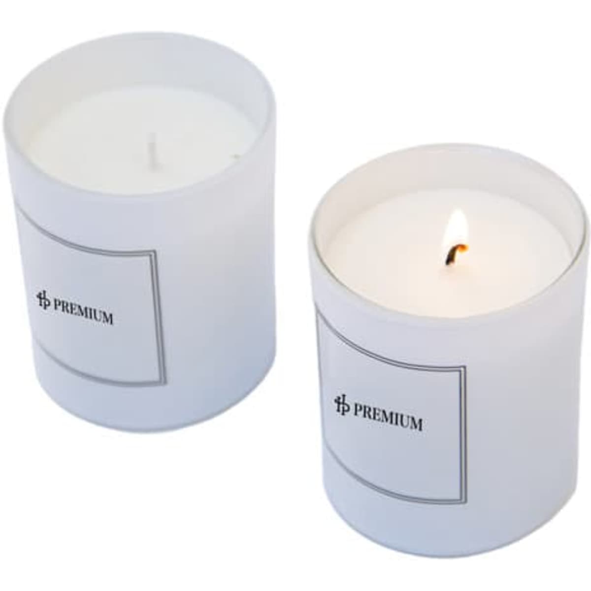 A set of two white glass scented candles, one lit, featuring a simple logo on the front of each container.