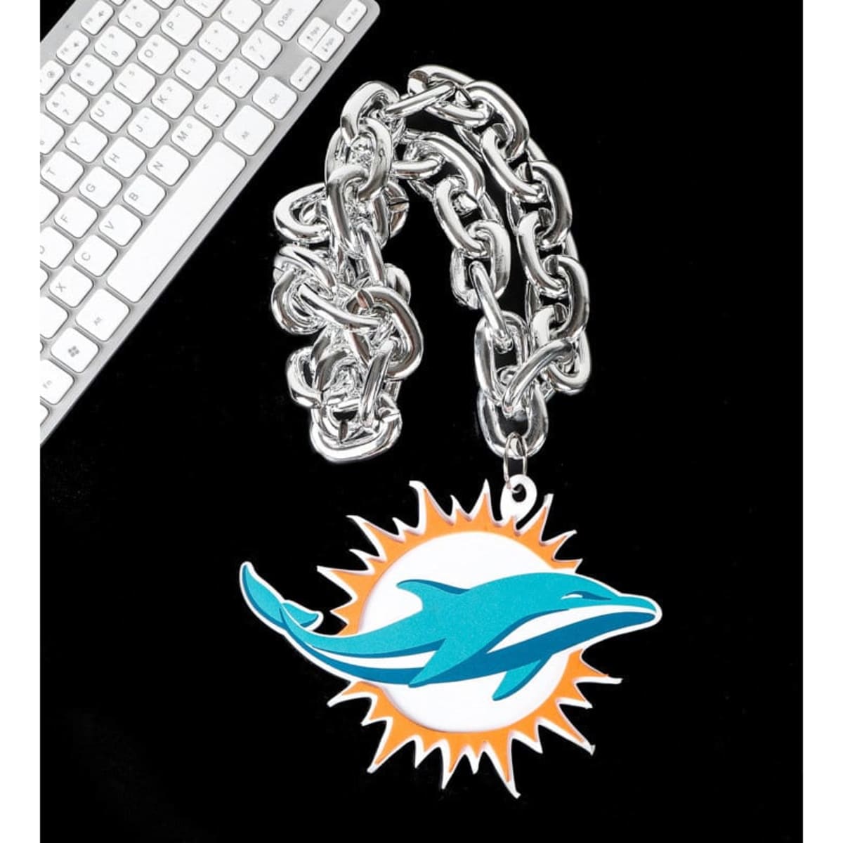 A large silver chain necklace featuring a colourful dolphin logo pendant on a black background.