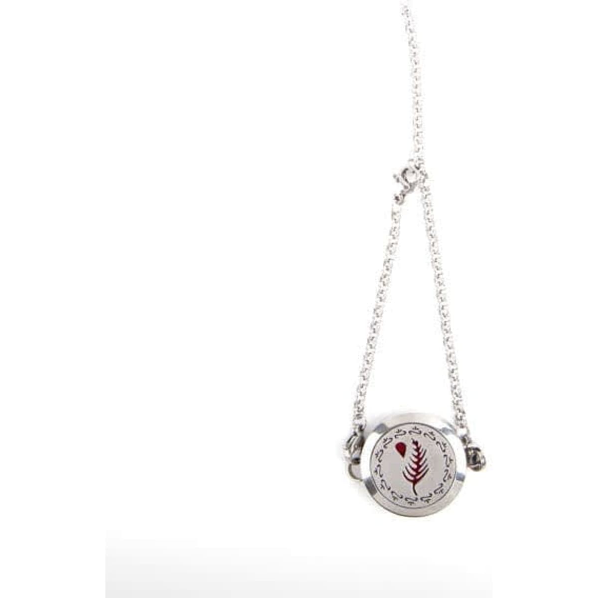 A silver essential oil diffuser locket pendant on a chain bracelet, featuring a decorative design.