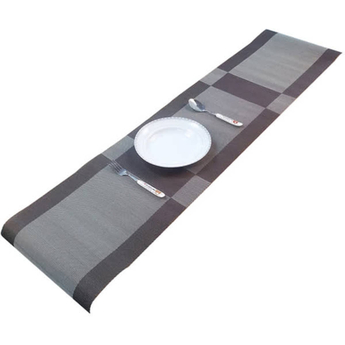 A grey and black woven placemat featuring a checkered pattern, with a plate and cutlery arranged on it.