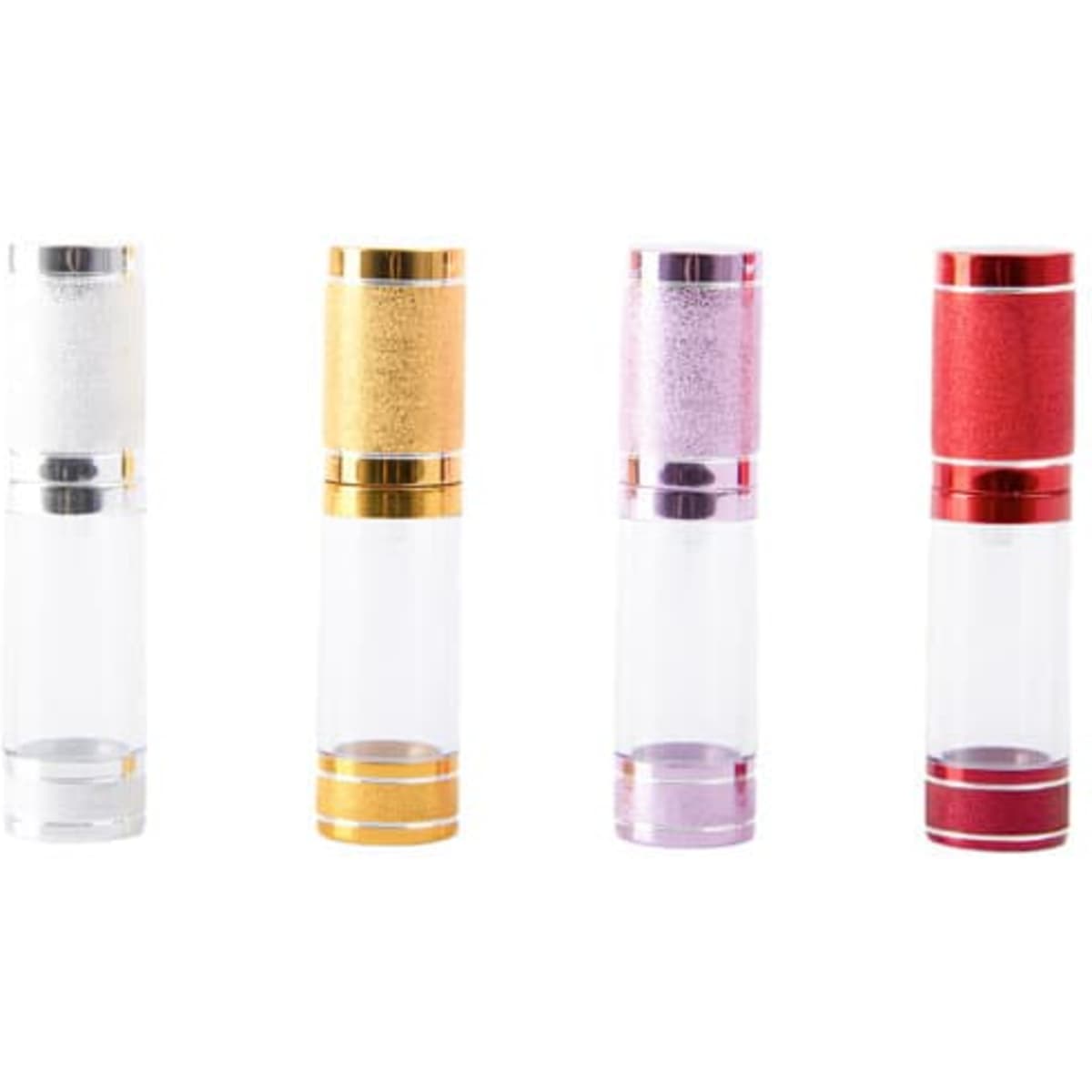 A set of four 15ml airless travel pump bottles in clear, gold, pink, and red with metallic accents.