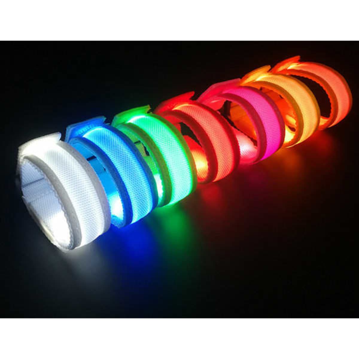 A set of adjustable nylon LED bracelets in various colours, including white, green, blue, red, and orange.