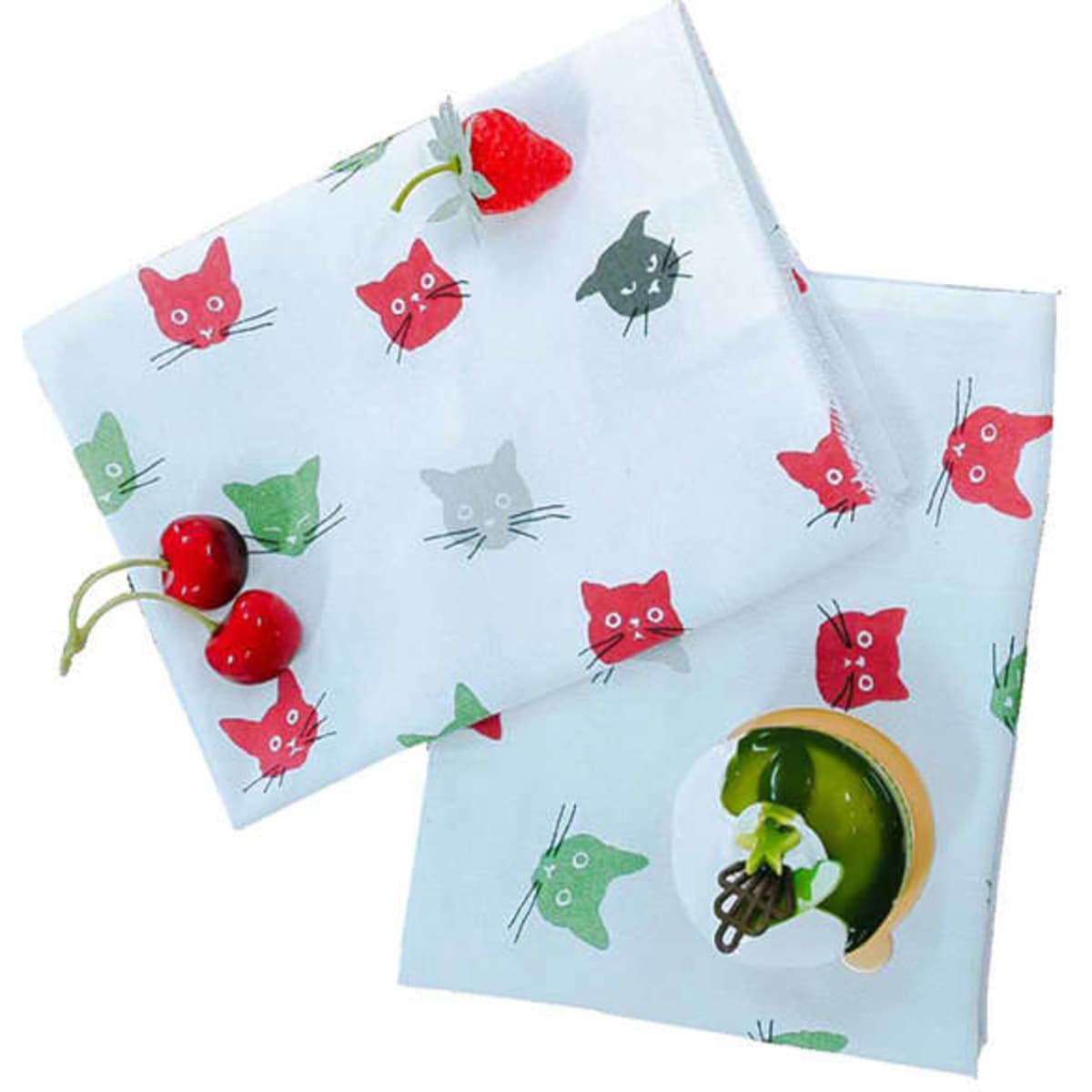 Two cotton kitchen towels featuring a playful cat pattern in red, green, and grey on a white background, accompanied by berries.