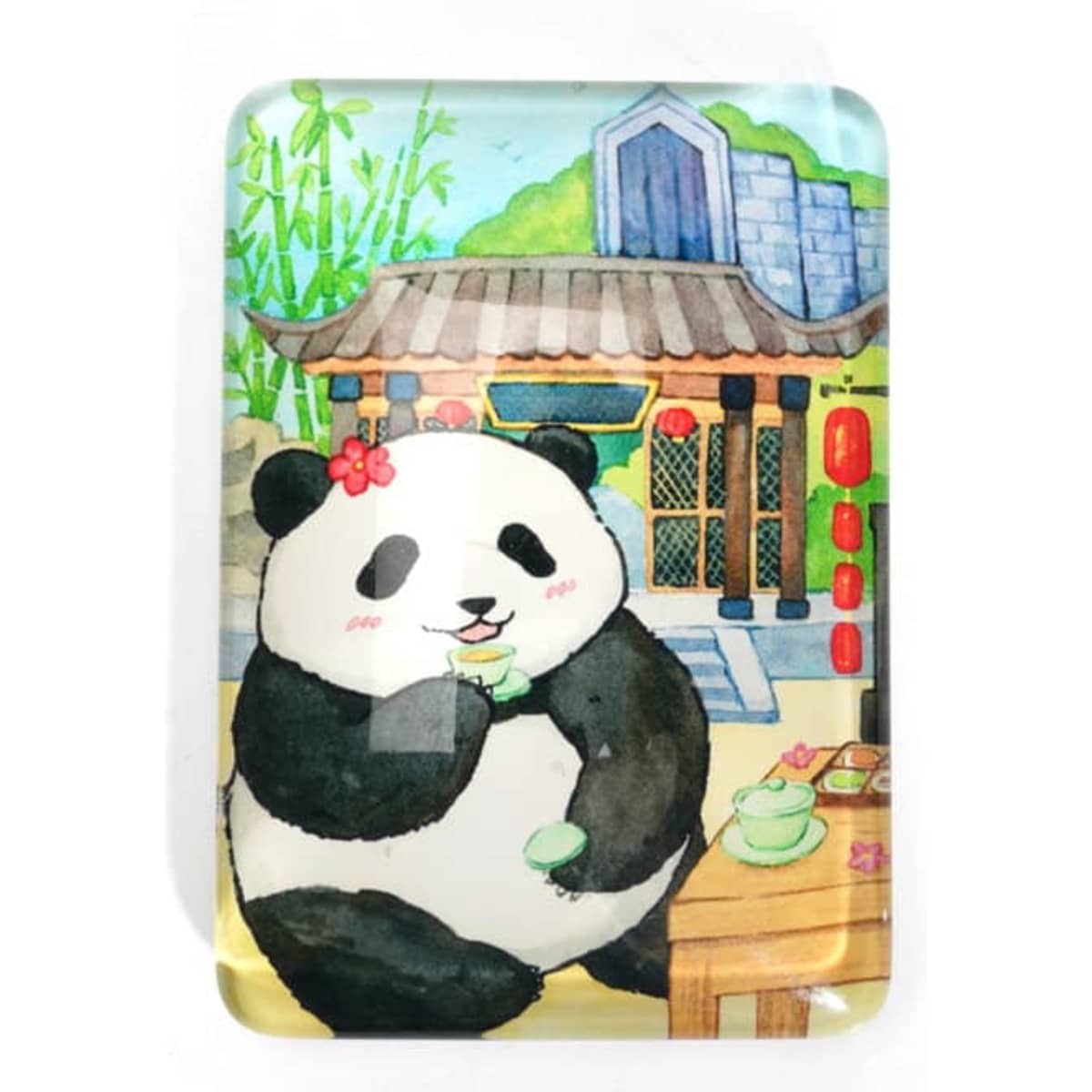 A custom glass fridge magnet featuring a cute panda in a tea setting, surrounded by bamboo and traditional buildings.