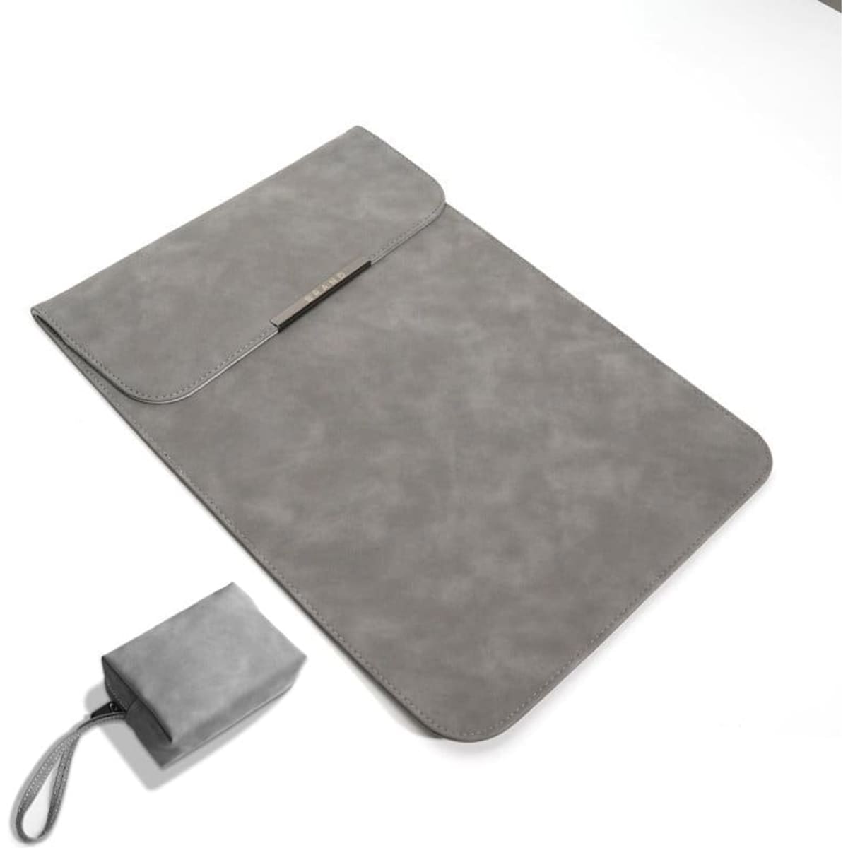 A grey laptop sleeve with a flap closure and a small pouch for a charger. It features a simple design and has a logo.
