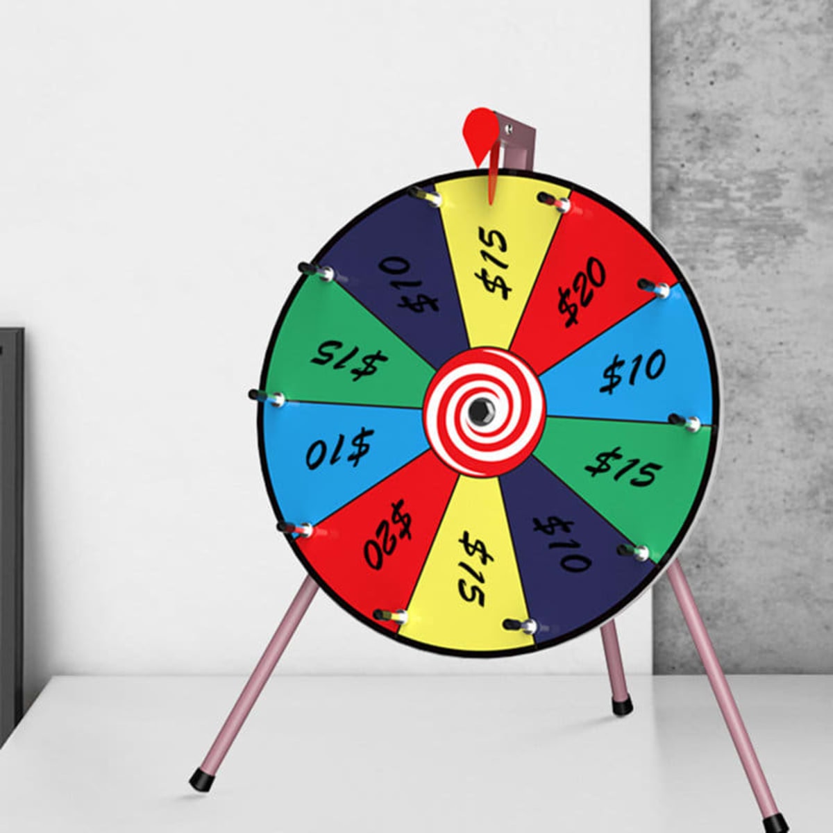 A colourful tabletop spinner wheel with segments in red, blue, yellow, and green, featuring various dollar amounts.