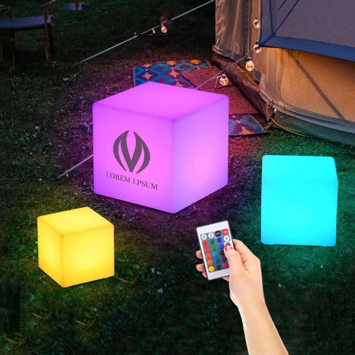 A set of glowing cubes in purple, yellow, and blue, featuring a logo, with a remote in hand.