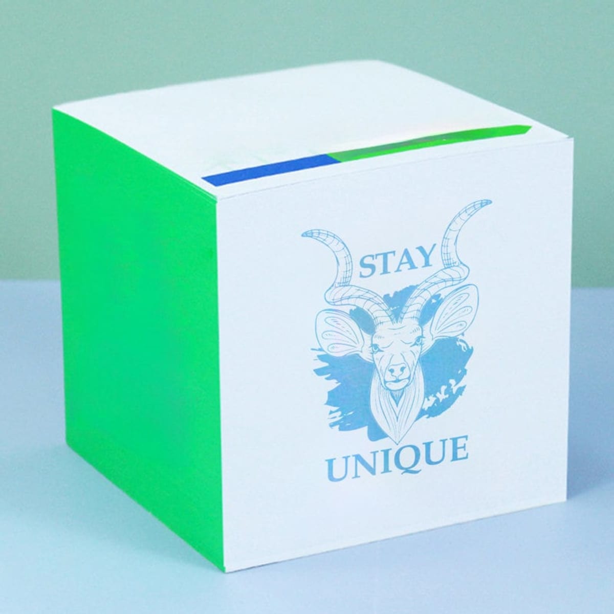 A sticky notes cube featuring a white body with a green side and a logo, designed for office use.