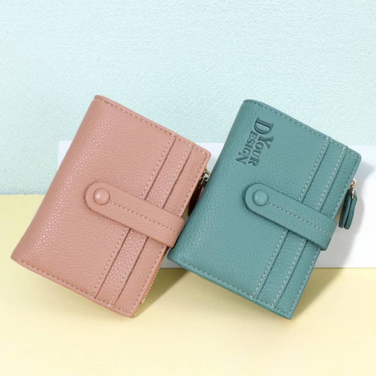 A lychee-pattern multi-card wallet featuring a pink and a green design, both with a logo and button closure.