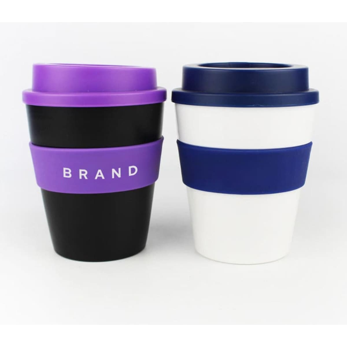 A set of two 12 oz. plastic coffee cups with silicone sleeves, one black with purple and one white with navy blue.