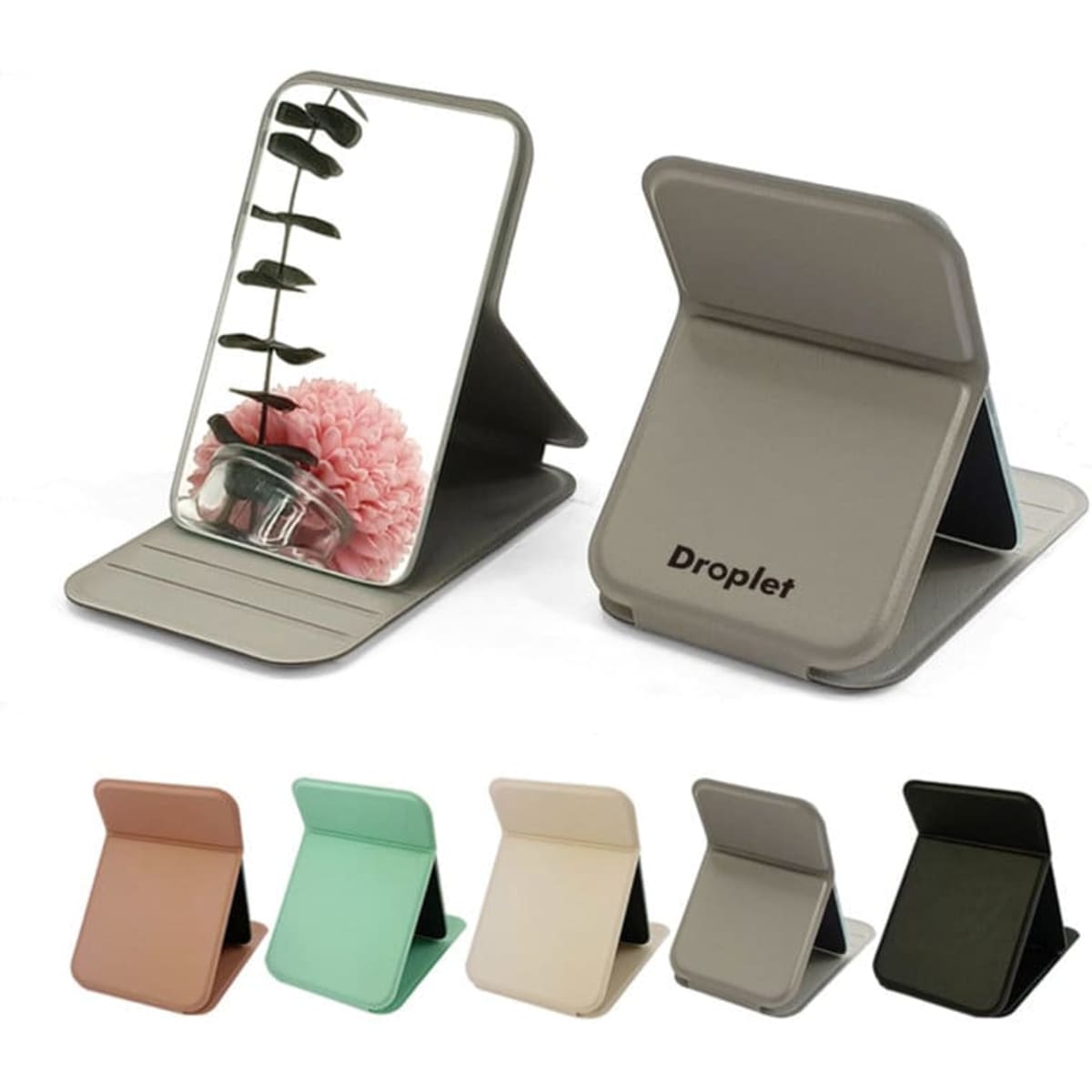 A portable folding mirror in several colours, featuring a sleek design and a small logo on the base.