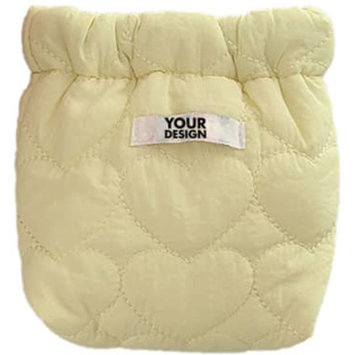 A quilted cosmetic bag in soft yellow with a heart pattern and a label for custom design.