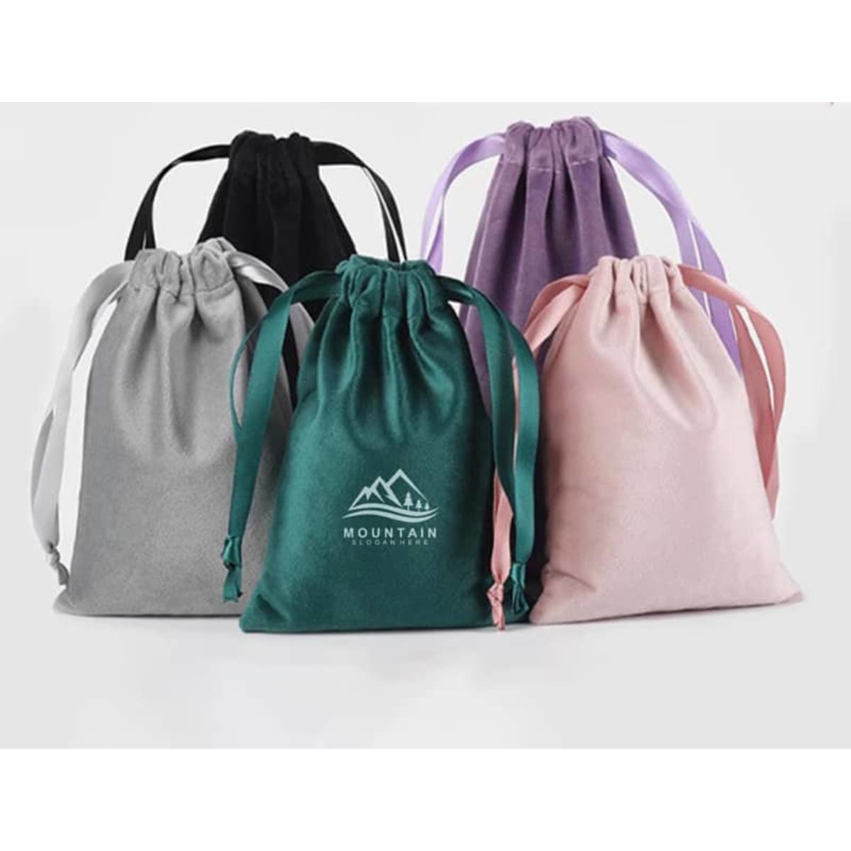 A set of five custom velvet gift bags in grey, green, black, purple, and pink, each with a drawstring closure and a logo.