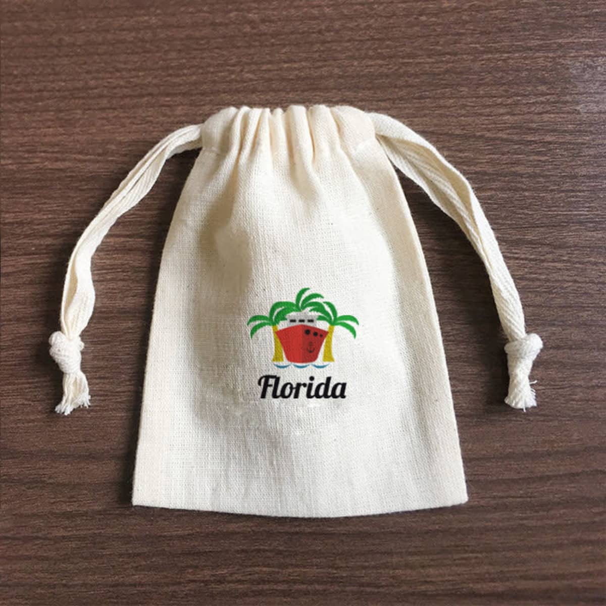 A cream-coloured custom cotton drawstring bag with a logo on the front and two drawstrings at the top.
