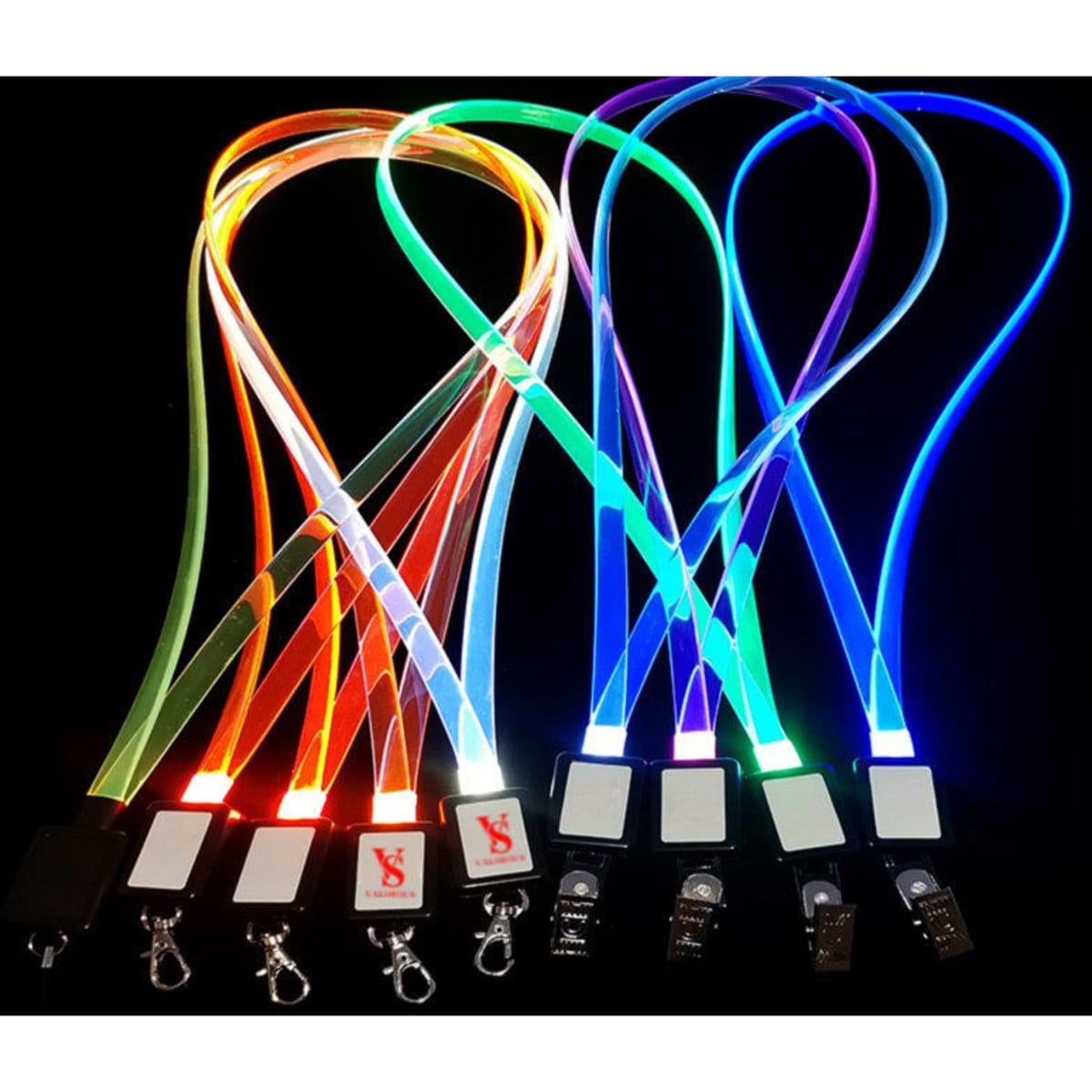 Brightly coloured LED lanyards in various hues including orange, green, blue, and purple, with clips and branding.