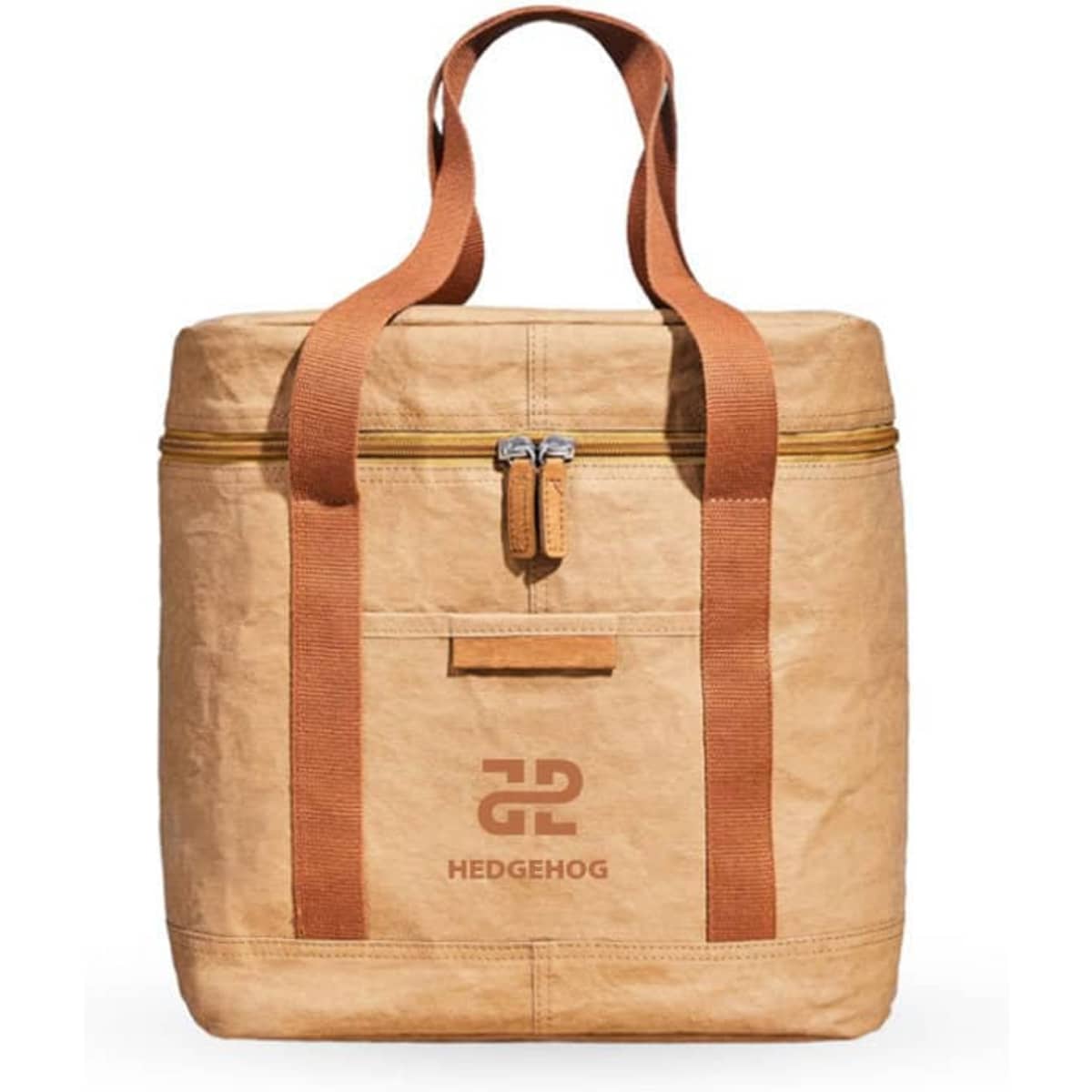 A tan insulated lunch bag with brown straps and a zip closure, featuring a logo on the front.