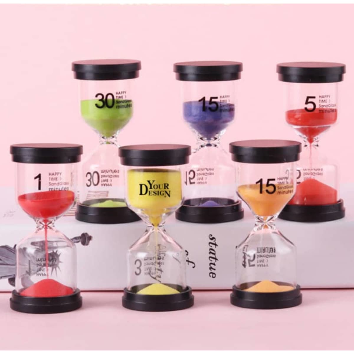 A set of six colourful sand timers in various shades, each with a black lid and different time markings.