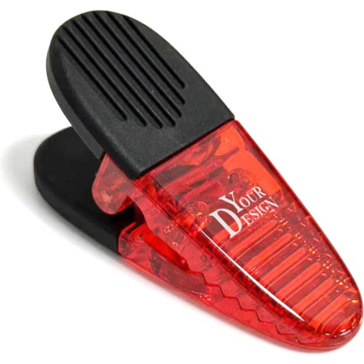 A red and black oval plastic magnetic clip featuring a design area and a textured gripping surface.