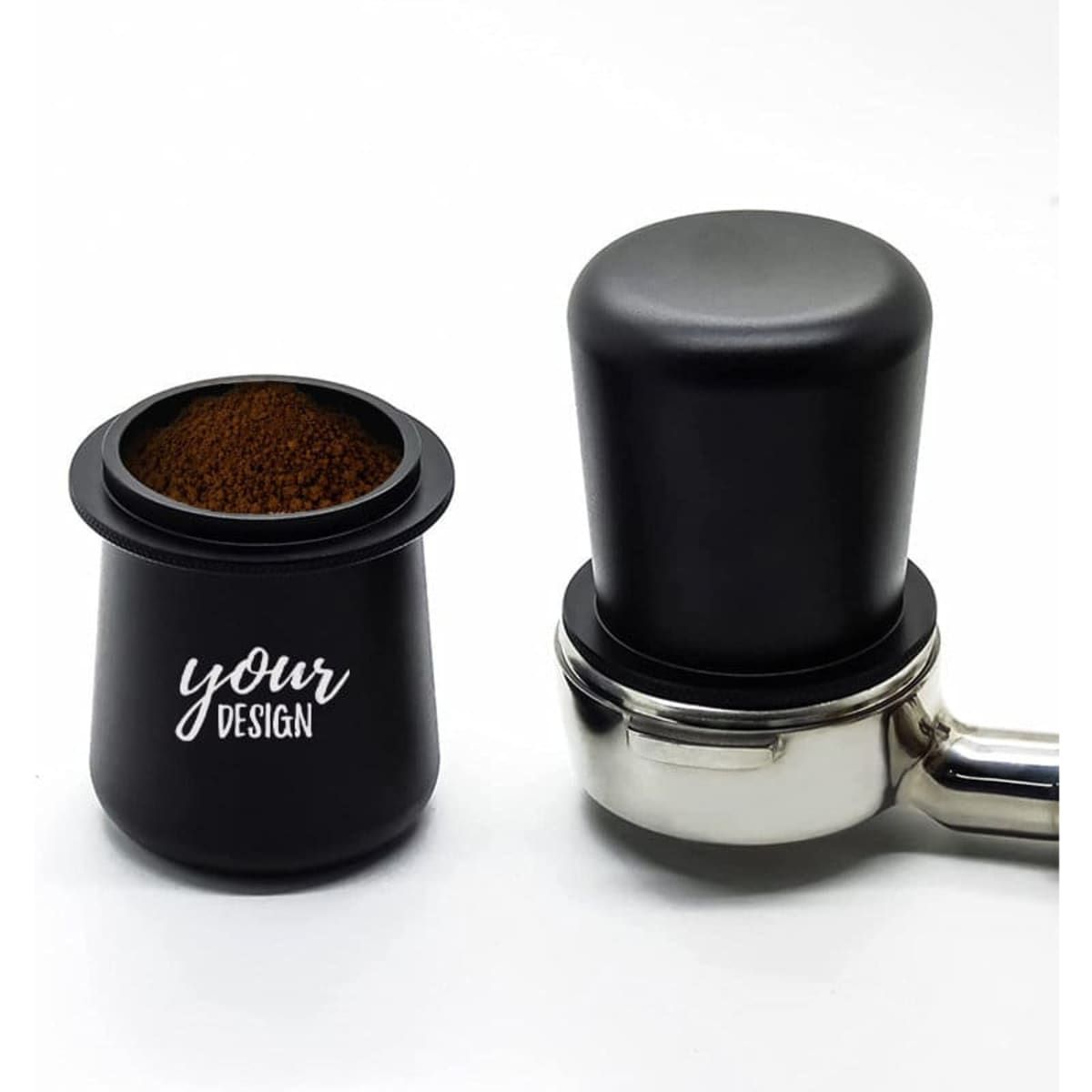 A black coffee portafilter dosing cup next to a shiny metal portafilter, filled with coffee grounds.