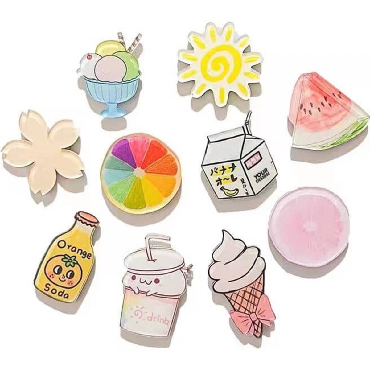 A collection of colourful acrylic magnets featuring food and drink designs, including ice cream, watermelon, and a sun.