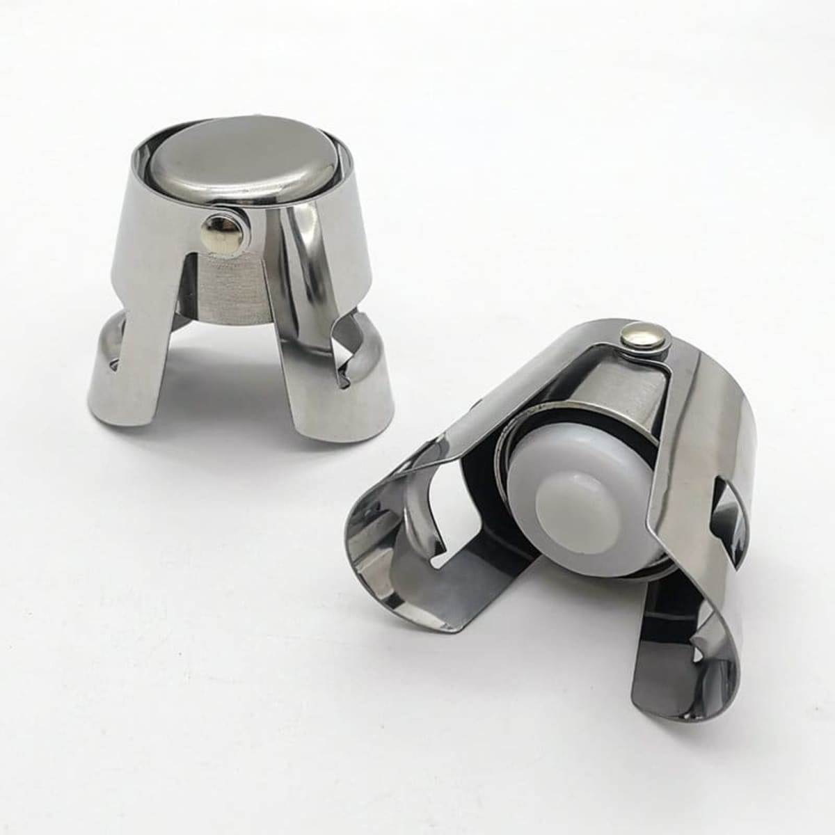A stainless steel champagne bottle stopper in silver, featuring a sleek design and a white sealing mechanism.