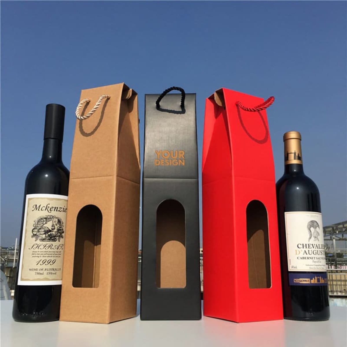 A drink bottle packaging bag with a window, featuring red, black, and brown colours, holding wine bottles.