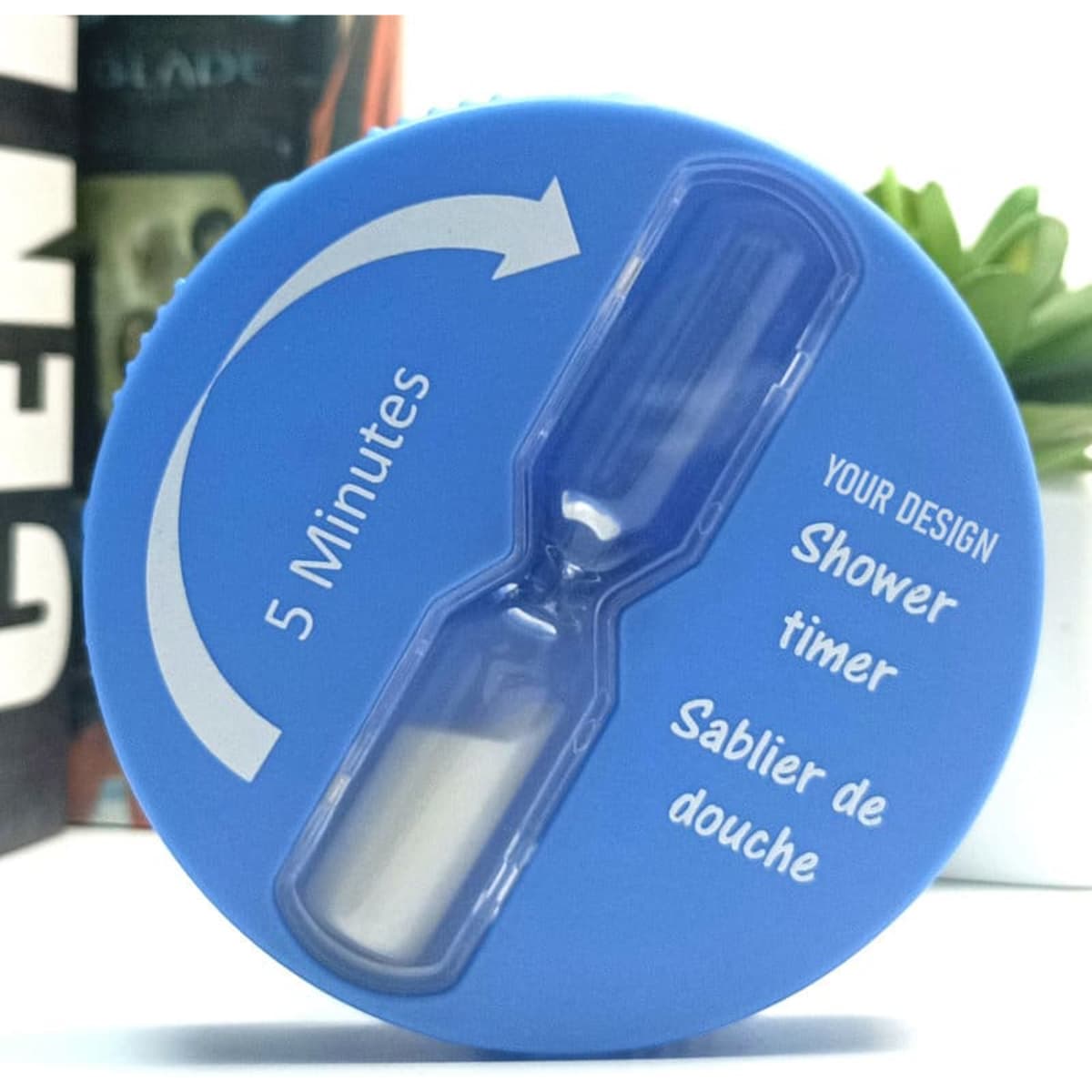 A blue hourglass shower timer with a suction cup, designed to measure five minutes. Features a space for custom design.