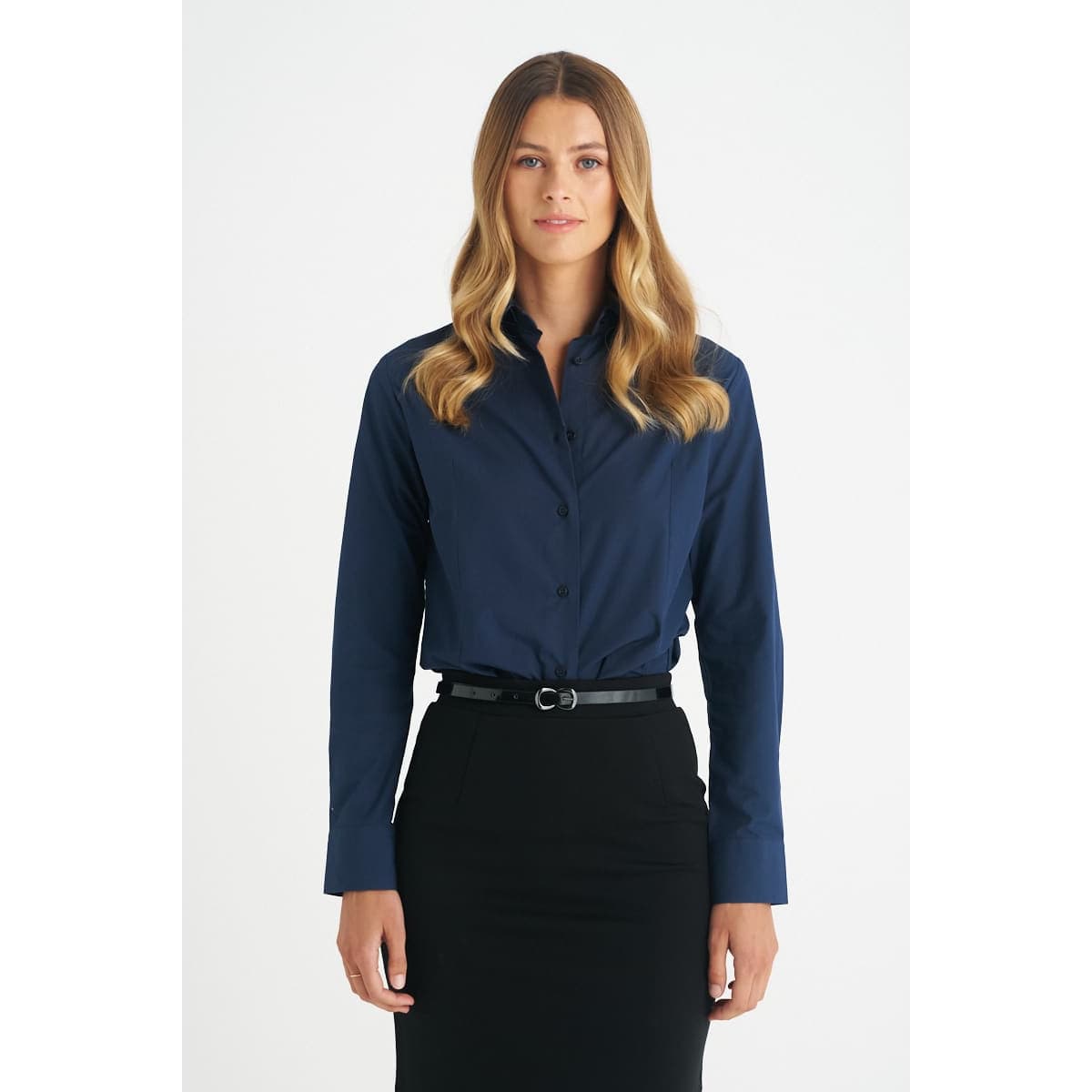 A ladies' long sleeve button-up shirt in navy blue, featuring a collar and button front, styled with a black belt.