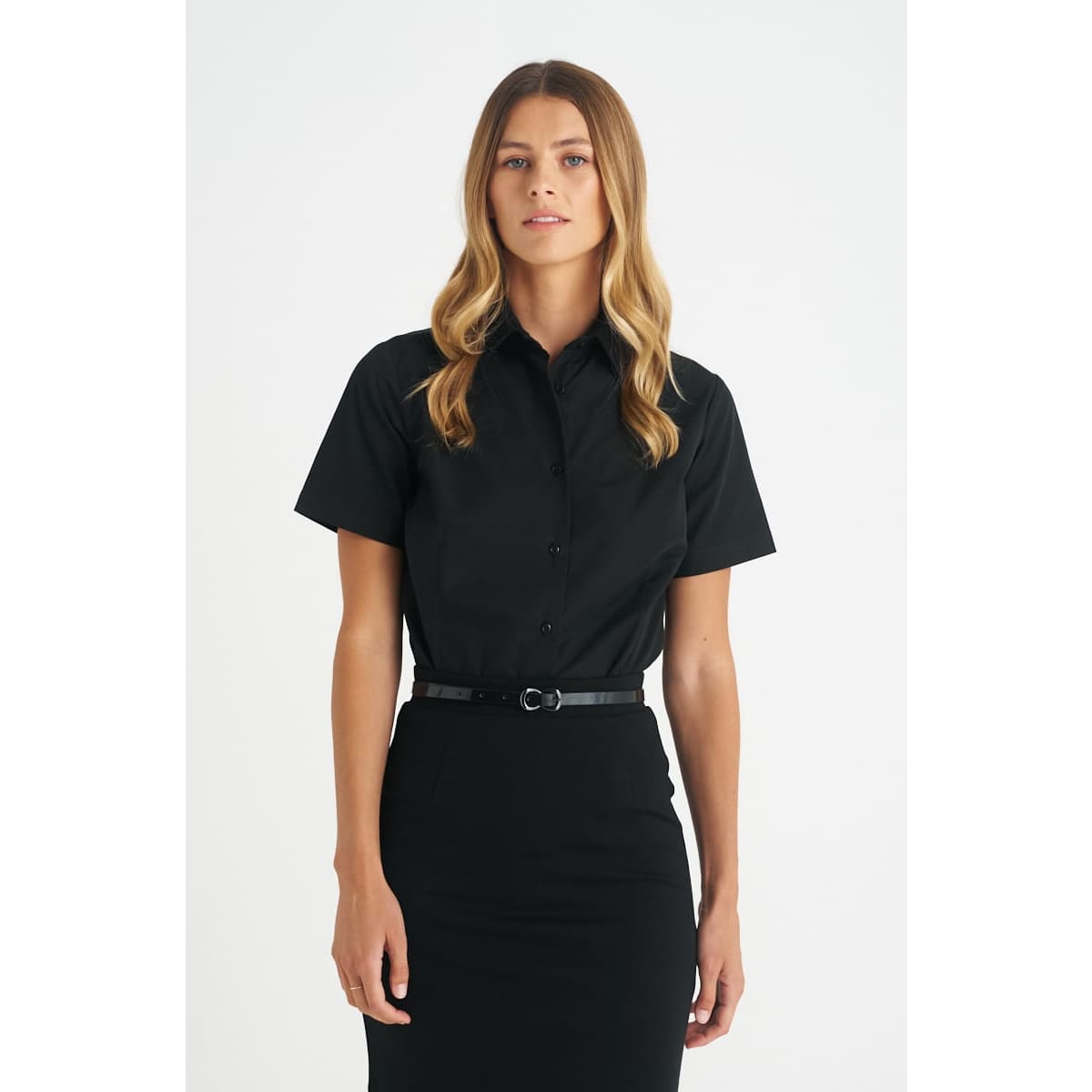 A black button-up short sleeve shirt for ladies, featuring a collar and a sleek fit. It has a logo on the garment.