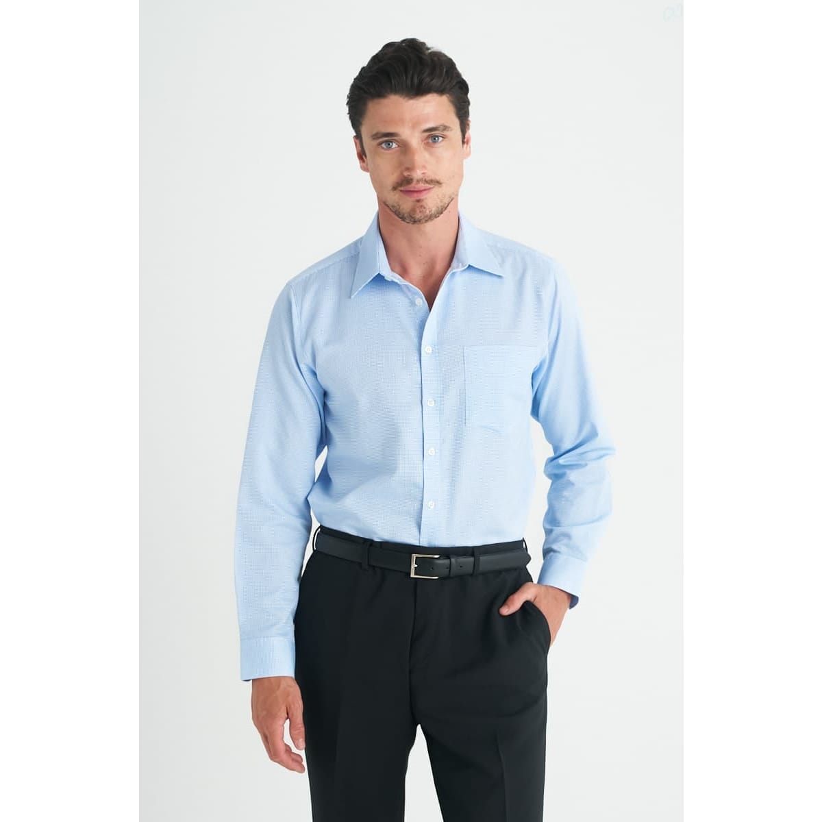 A light blue men's long sleeve button-up shirt with a chest pocket, paired with black trousers.