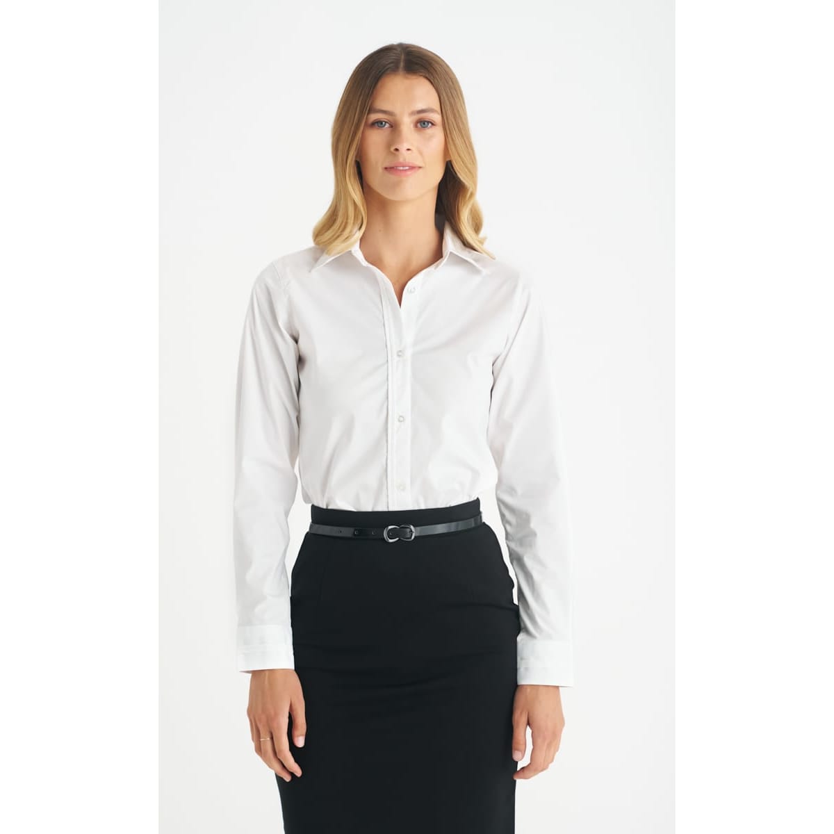 A white ladies long sleeve button-up shirt, styled with a black skirt, featuring a logo on the garment.