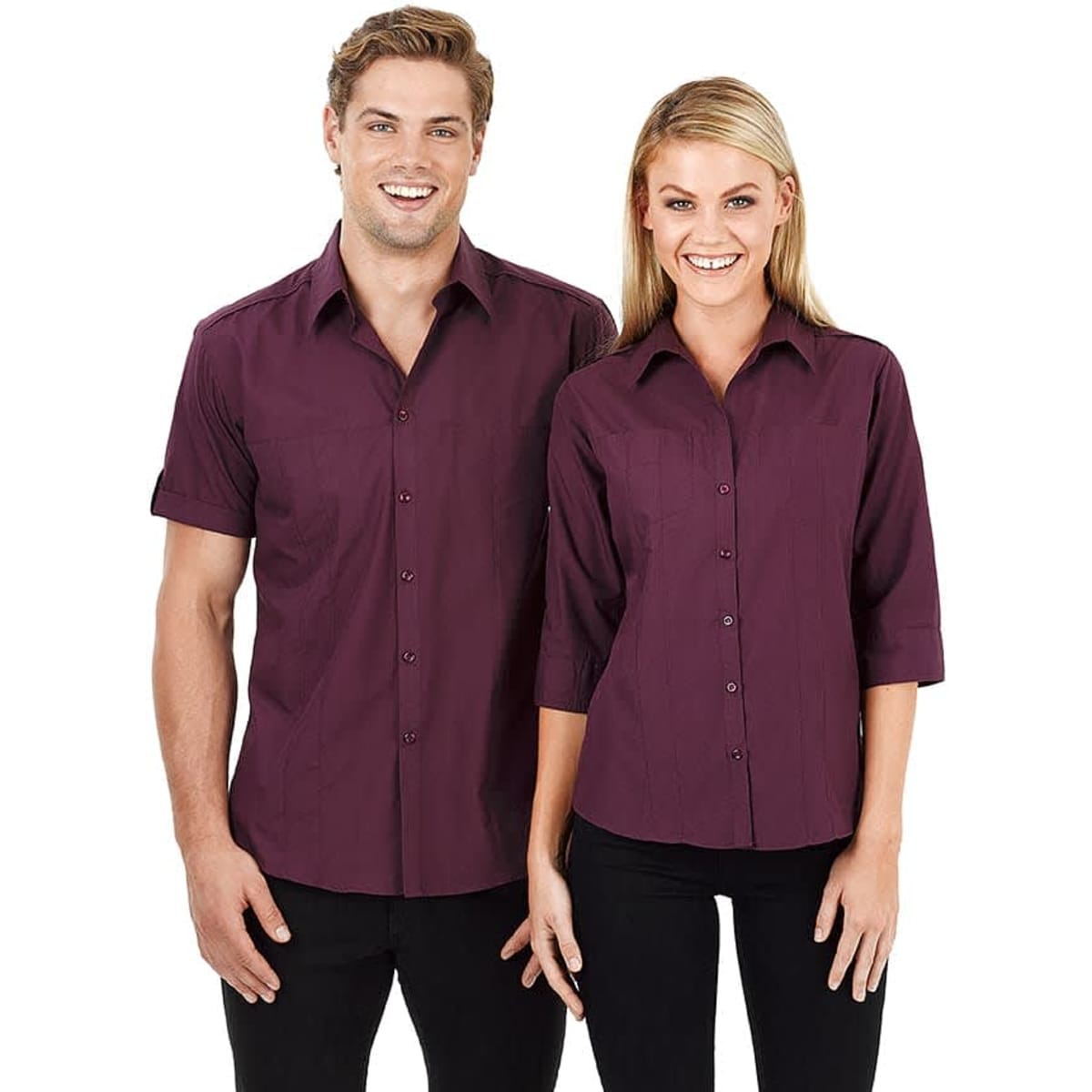 A dark burgundy button-up shirt in short sleeves for men, paired with a similar style for women. Both feature a logo.