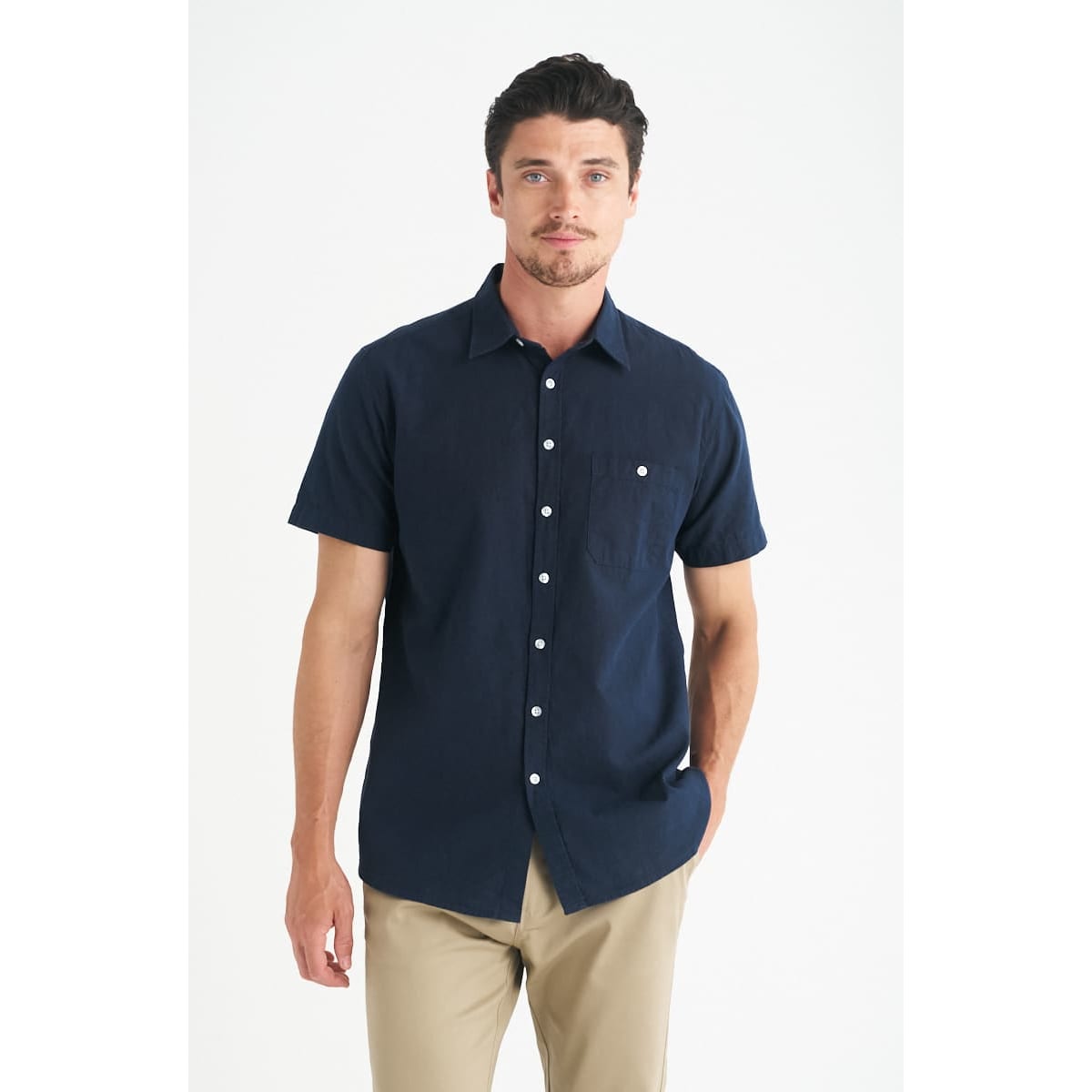 A men's short sleeve shirt in navy blue with a pocket and button-up design. Features a logo on the chest.