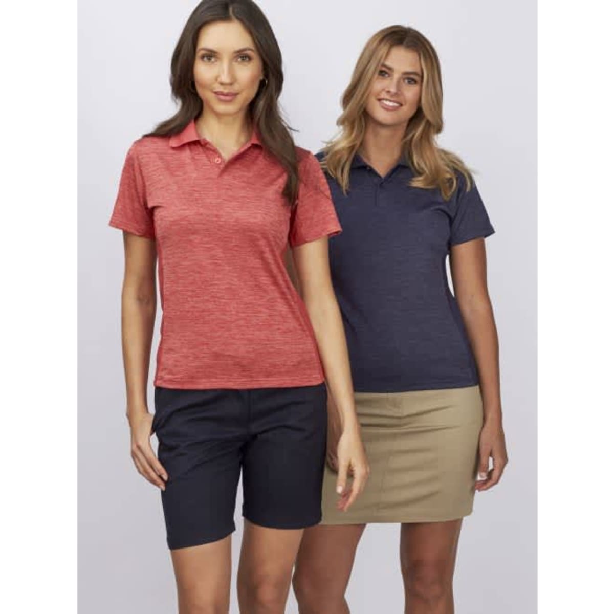 Two women wearing polo shirts in red and navy, standing side by side against a plain background.