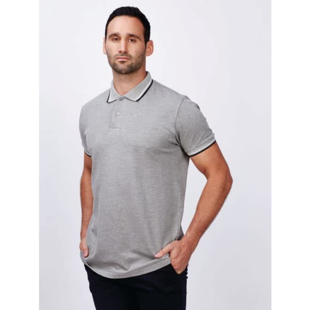 A men's grey polo shirt with contrasting trim and a logo on the chest, styled on a male model.