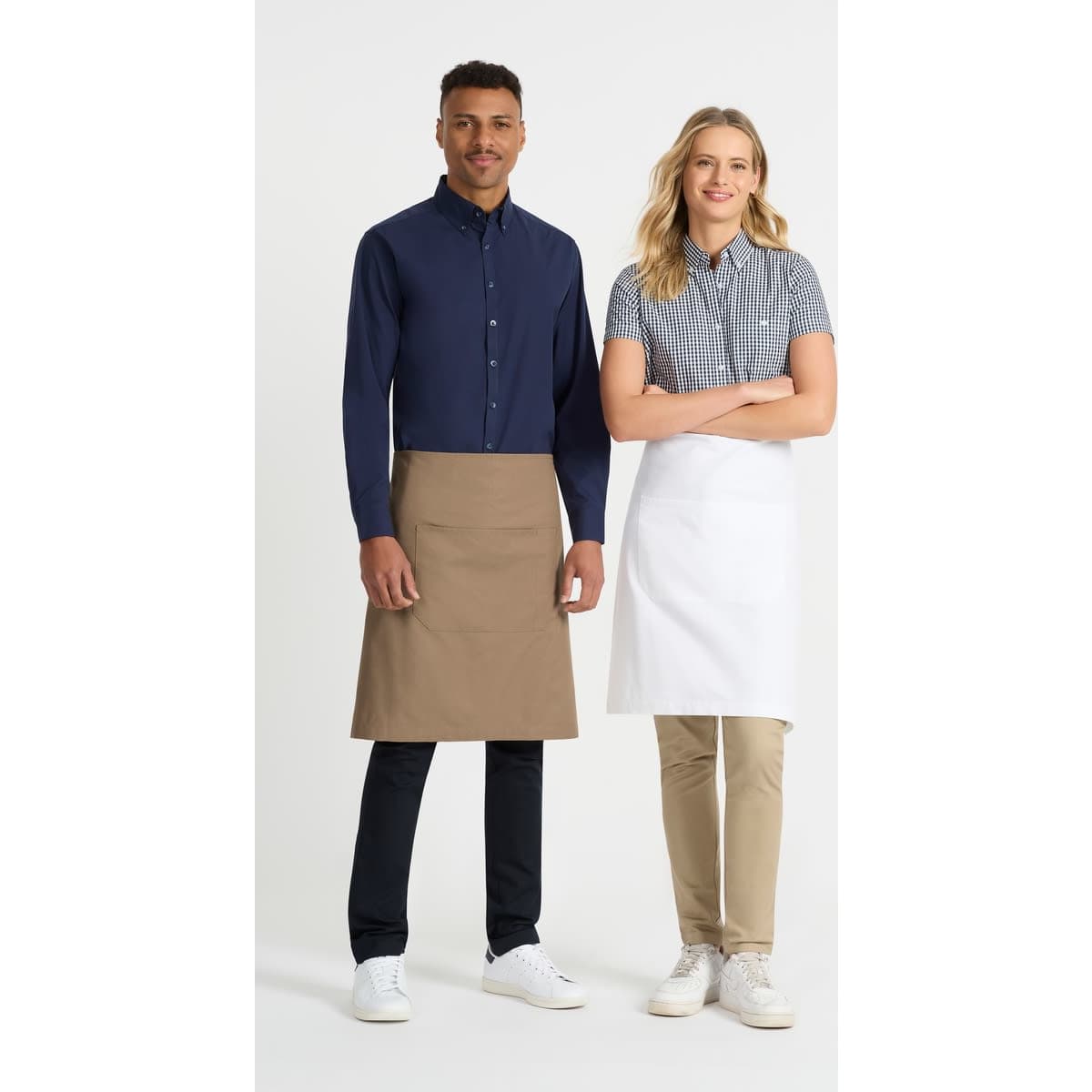 A navy blue button-up shirt and a checkered short sleeve shirt worn by two models, each in an apron.
