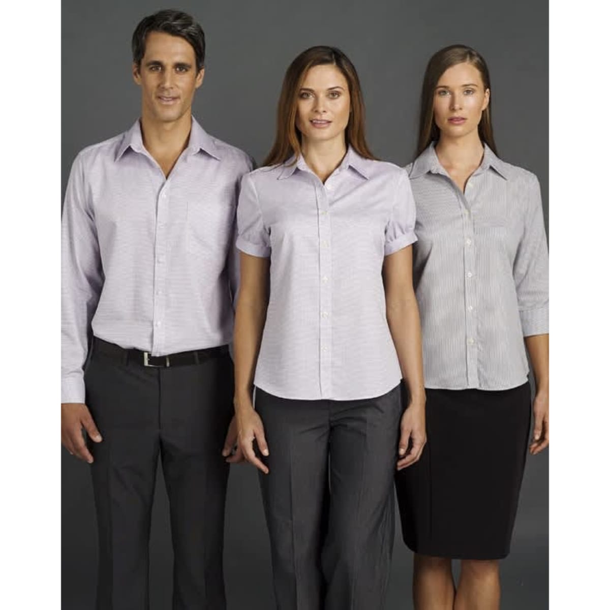 A button-up shirt in light purple, worn by a male and two females, showcasing short and long sleeve styles. It features a logo.