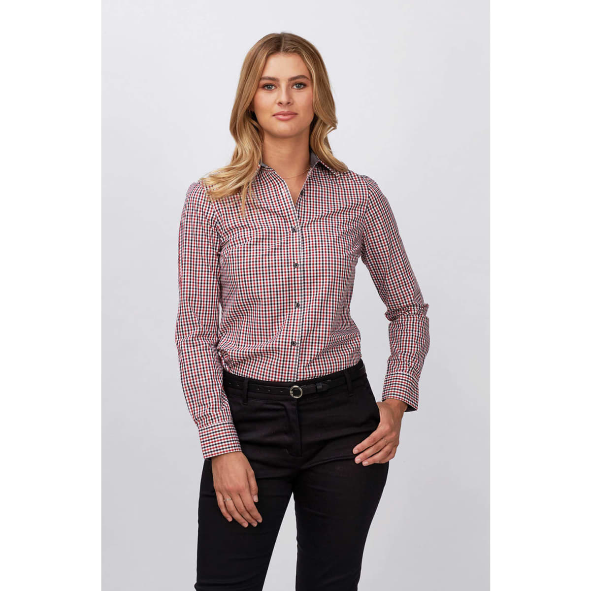 A lady’s long sleeve shirt in a red and white check pattern, featuring a button-up front and a logo.